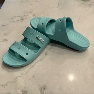 Crocs light blue sandals.